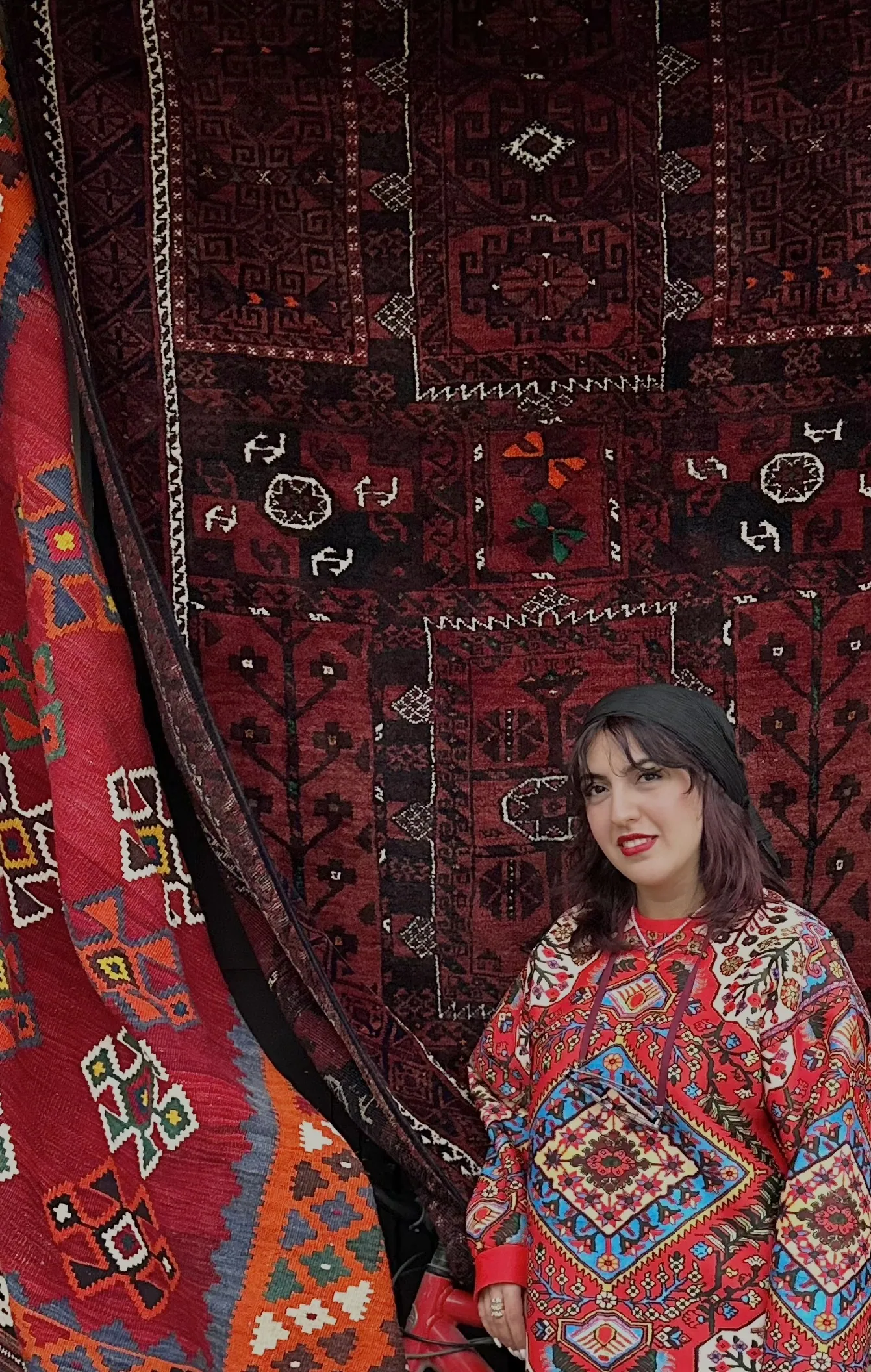 Lily Shaker standing in front of traditional Persian rugs